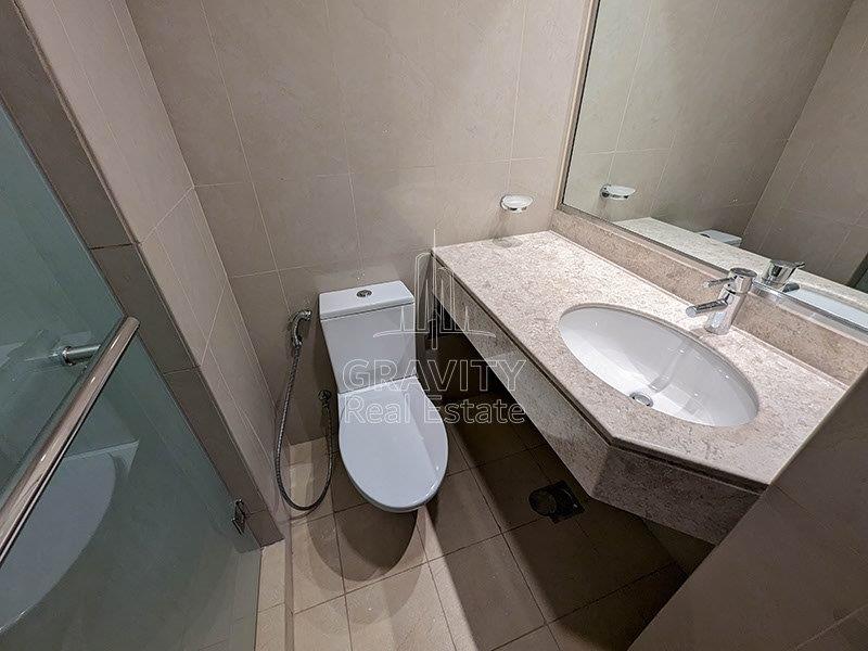 clean-washroom-with-attached-sink-and-mirror-in-sun-towers