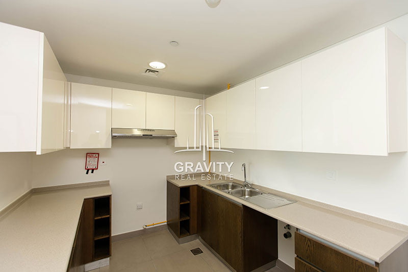 kitchen-with-brown-and-white-cabinets-in-3-bedroom-apartment-wave-tower-reem-island