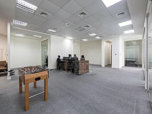 large-office-area-with-a-foosball-table-and-a-big-office-table-surrounded-with-six-comfy-office-chairs-office-in-addax-tower