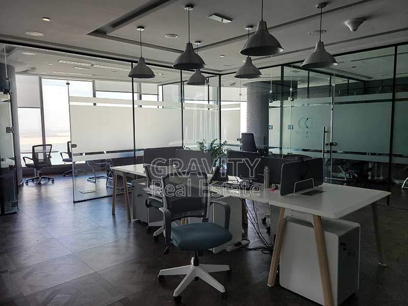 large-office-space-with-whte-long-tabe-in-the-middle-and-decor-plants-on-the-table-nicely-furnished-addax-office-tower