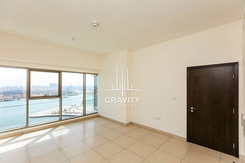 master-bedroom-with-dark-wooden-door-and-large-windows-with-excellent-sea-view-in-wave-tower-reem-island