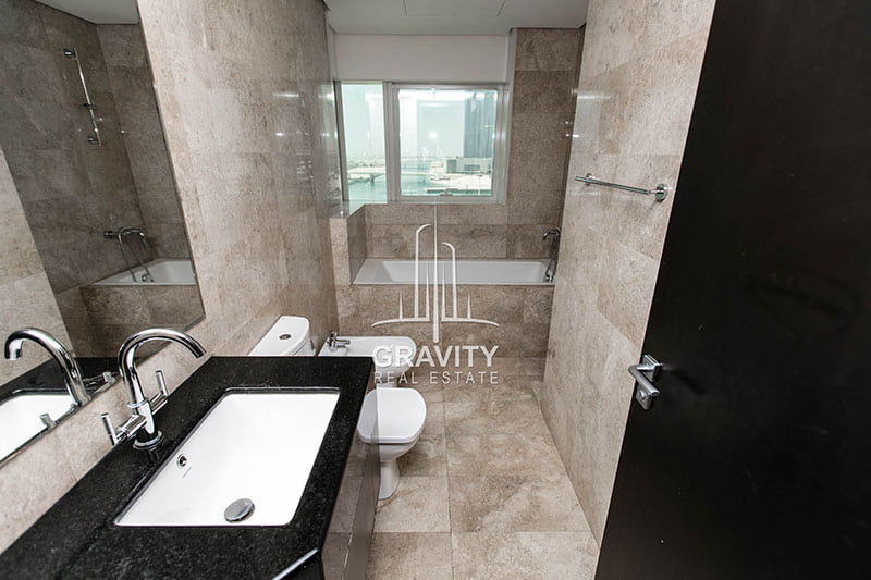 neat-and-sleek-bathroom-with-bath-tub-modern ceramic tile furnishing-in-1-bedroom-apartment-ocean-terrace-reem-island