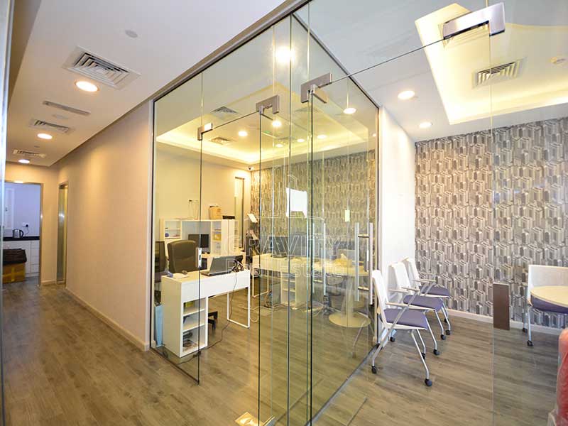 nice-separated-office-room-with-glass-panels-covering-the-front-side-of-and-gray-color-printed-design-walls-in-addax-tower