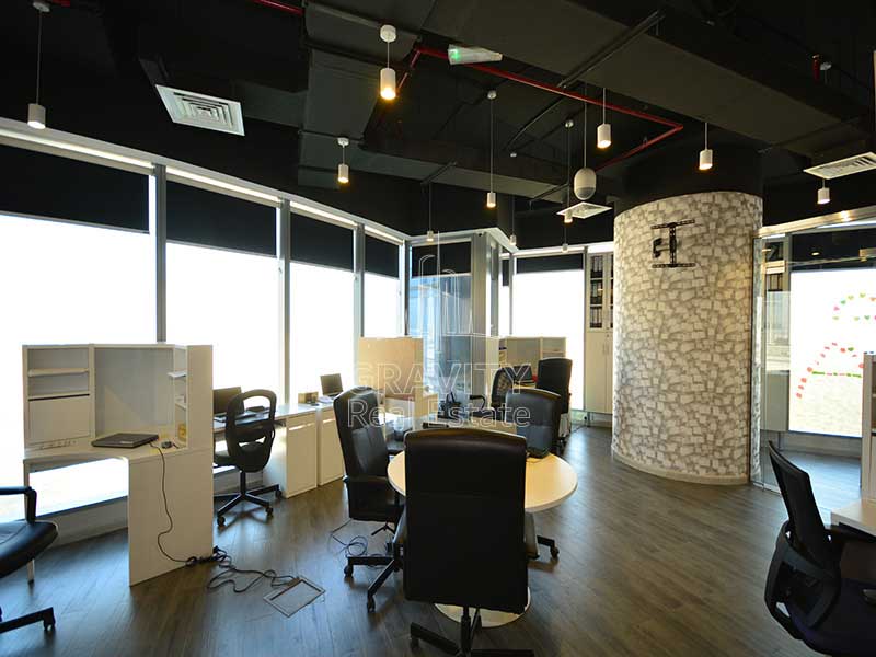 office-area-with-black-color-office-chairs-surrounding-the-table-and-windows-facing-the-outside-view-in-addax-tower