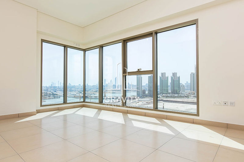 spacious-living-room-with-huge-windows-and-marble-tiles-in-wave-tower-reem-island-apartment