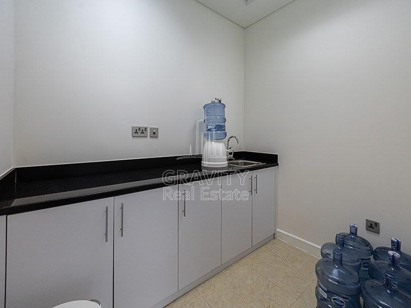 wet-pantry-with-water-cans-and-white-cupboard-office-in-addax-tower