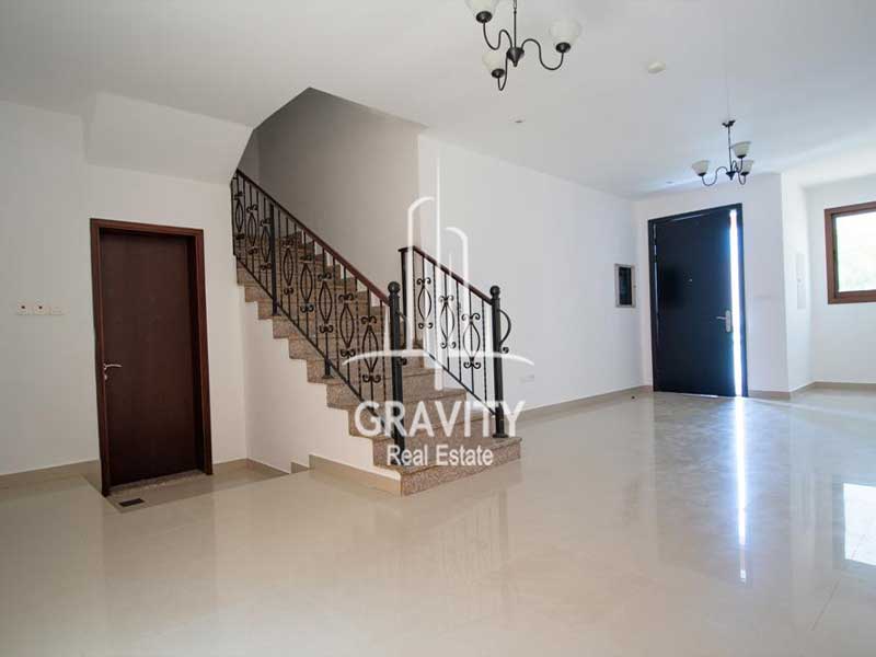 Big-hall-area-with-the-charm-stairs-in-the-middle-leading-to-the-spacious-2-nd-floor-andthe-entrance-door-next-to-it-hydra-villa