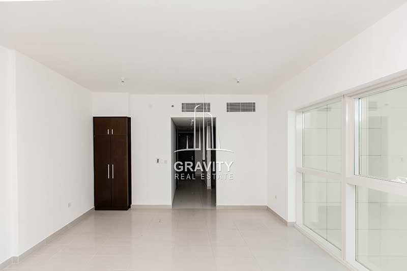 Living-room-with-built-in-wardrobe-in-the-corner-in-studio-for-sale-in-Abu-dhabi