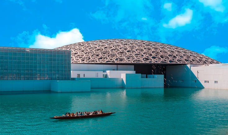 Louvre-abu-dhabi-as-seen-from-waters-with-people-on-wooden-boat-nearby