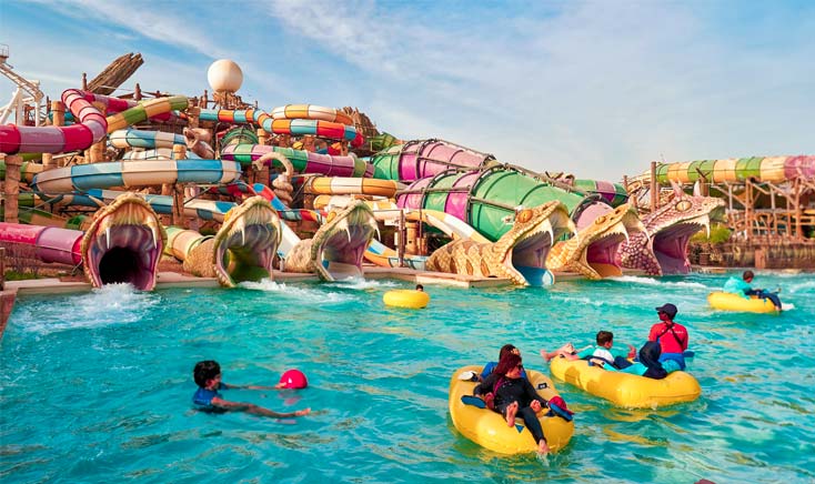 yas-waterworld-snake-slides-with-people-on-floating-tubes-on-the-pool