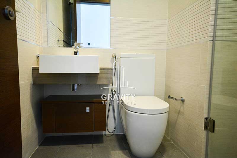 bathroom-with-white-toilet-and-sink-in-studio-apartment-in-gate-tower-1