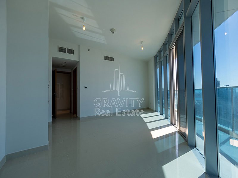 bedroom-with-large-floor-to-ceiling-windows-in-apartment-in-julphar-tower-residence