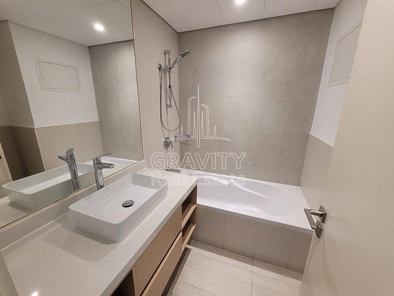 bright-washroom-with-clean-bath-tub-and-sink-area-the-bridges-abu-dhabi