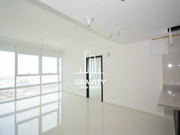 calssy-lving-area-with-large-window-panels-providing-the-room-a-stunning-view-of-the-outside-horizon-tower-reem-island