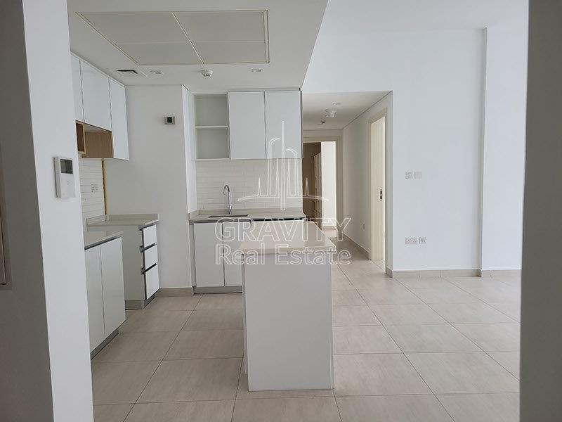 clean-and-spacious-big-kitchen-with-nice-white-cupboards-with-wooden-touched-on-top-in-the-bridges-abu-shabi