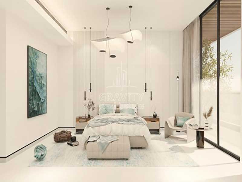 cozy-living-room-with-lights-hanging-from-the-cieling-nad-big-window-panel-on-the-side-wall-from-the-bed-in-sea-la-vie-yas-island