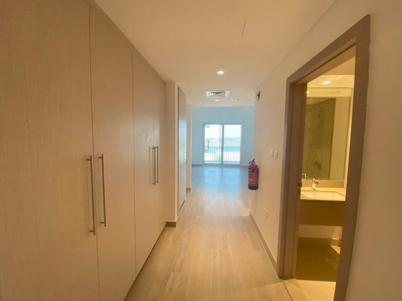 cozy-studio-wtih-built-in-wardrobes-o-the-left-wall-and-the-washroom-on-the-right-waters-edge-yas-island