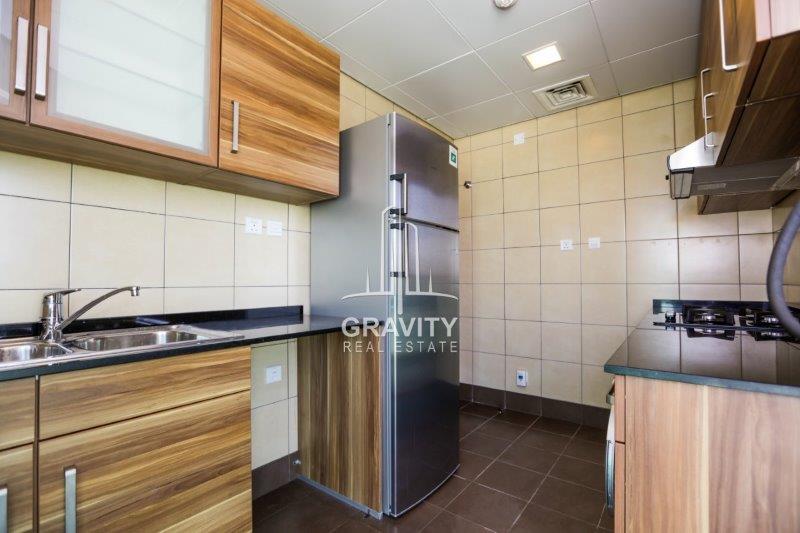 fitted-kitchen-with-wooden-touched-cupboards-and-nicely-marbled-floor--in-beach-tower-reem-island