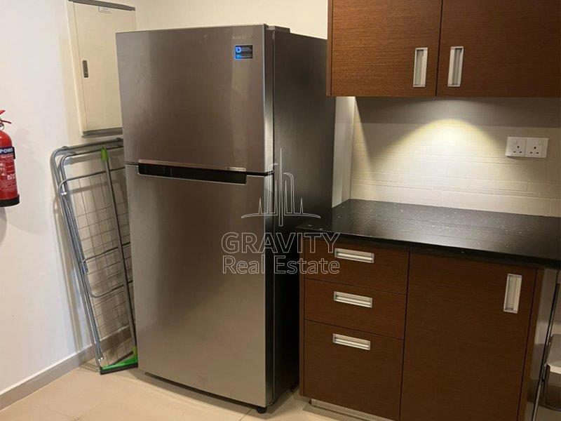 great-modern-kitchen-with-appliances-brown-cabinets-in-a-studio-in-gate-tower-2-apartment