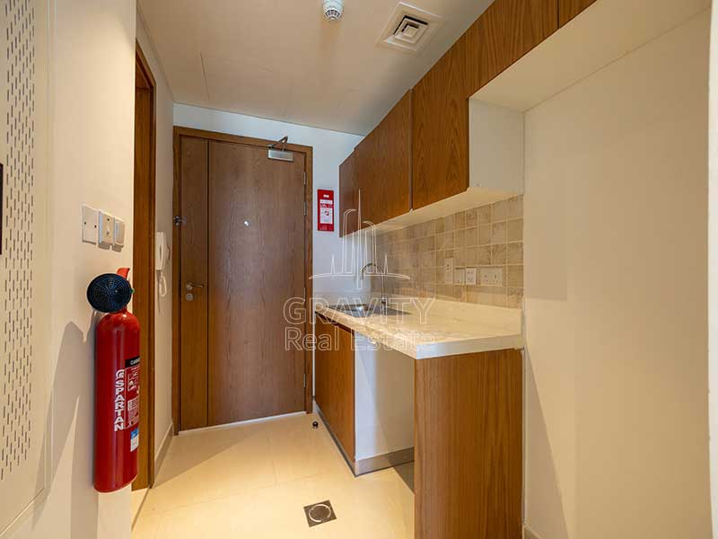 kitchen-and-entrance-of-studio-apartment-in-julphar-residence-abu-dhabi