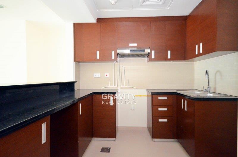 kitchen-w-brown-cabinets-and-cupboards-in-the-gate-towers-2-apt