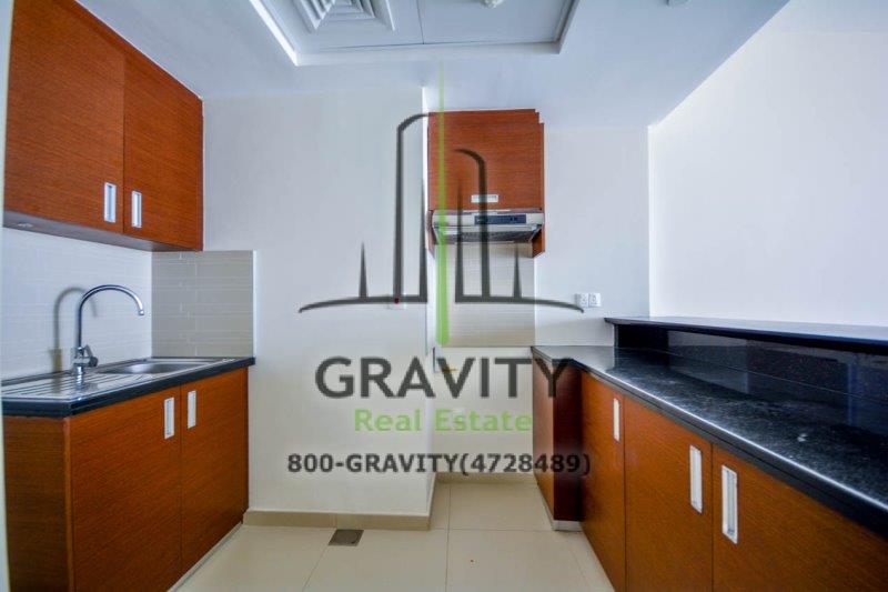 kitchen-with-brown-cabinets-in-1-bedroom-apartment-in-arc-tower-b