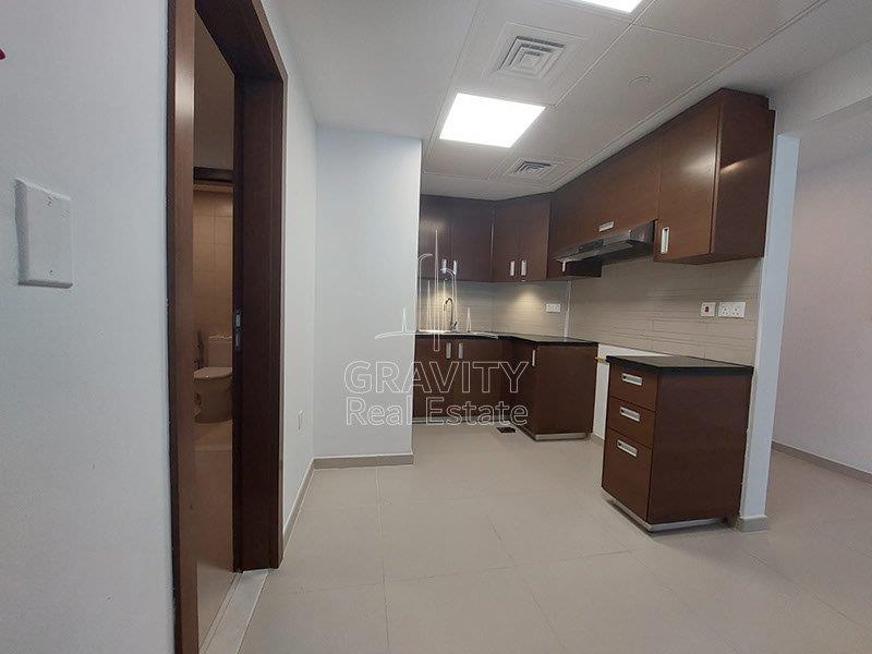 kitchen-with-brown-cabinets-in-3-bedroom-apartment-in-the-gate-tower-1