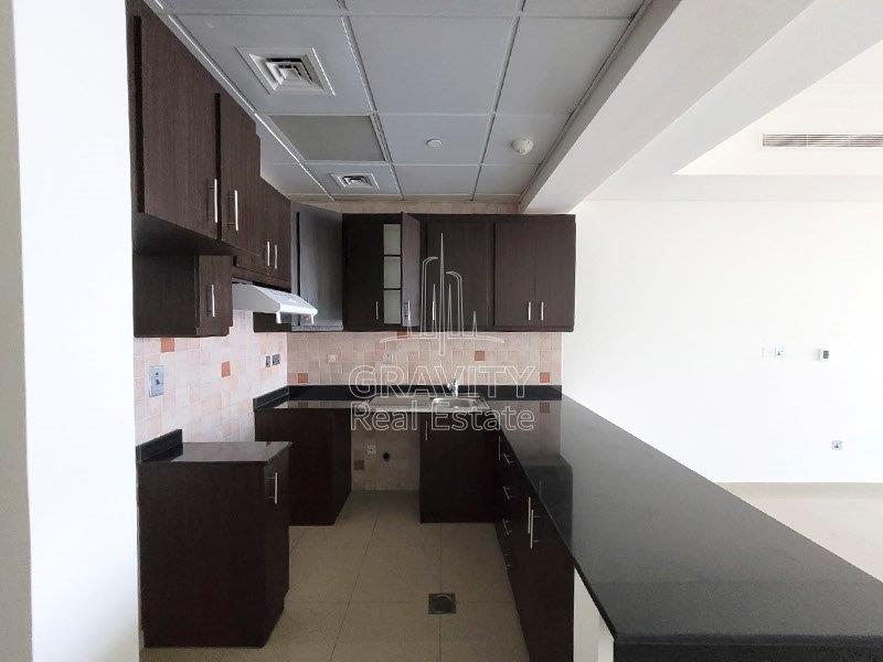 kitchen-with-marble-counter-top-dark-colored-cup-board-and-cabinets