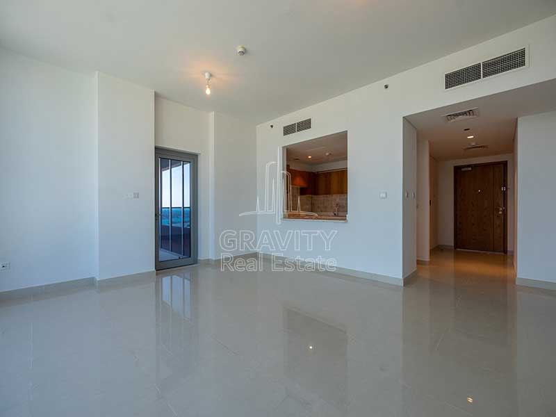 living-room-with-spacious-open-kitchen-in-3-bedroom-apartment-in-julphar-residence-al-reem-island