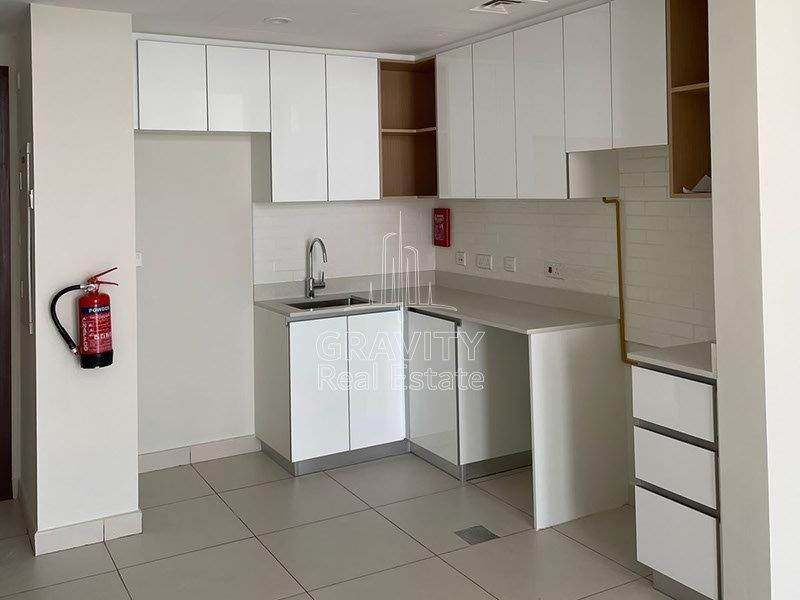 neat-and-modern-kitchen-w-white-cupboards-and-cabinets-in-shams-reflection-tower-1bedroom-apartment-for-rent