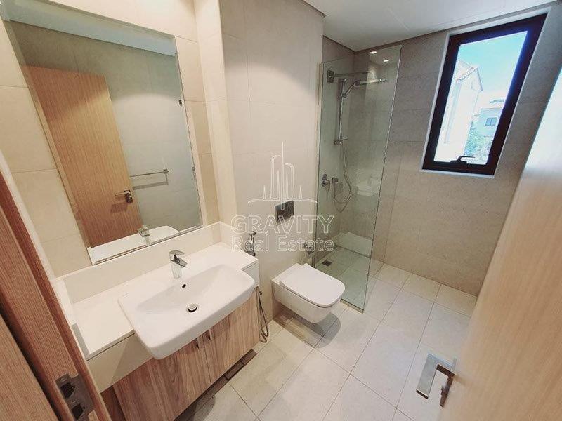 neat-shower-room-with-sink-vanity-mirror-toilet--ina-a-2-bedroom-townhouse-in-bloom-garden-abu-dhabi-for-rent