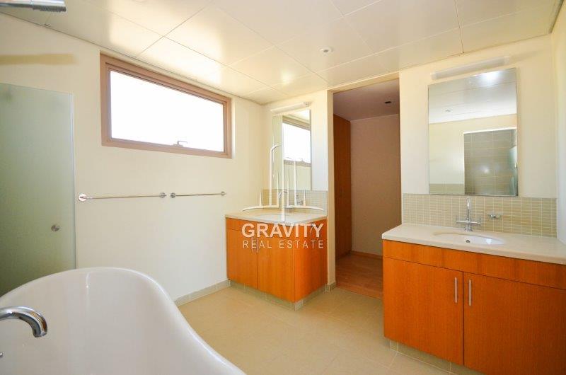 nice-washroom-with-brown-cabinets-vanity-mirrors-in-al-raha-gardens-townhouse