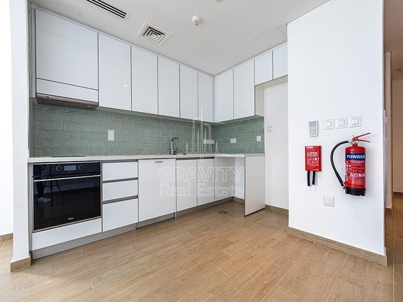 nicely-finished-open-kitchen-area-with-a-fire-extinguisher-mounted-to-the-wall-just-in-case-if-something-goes-wrong--in-mayan-apartments