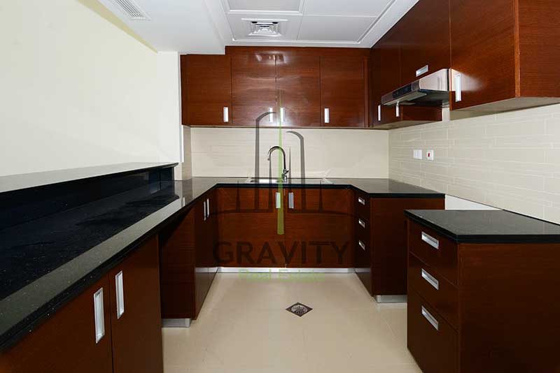 open-kitchen-with-dark-brown-cabinets-in-in-1-bedroom-apartment-in-gate-tower-3