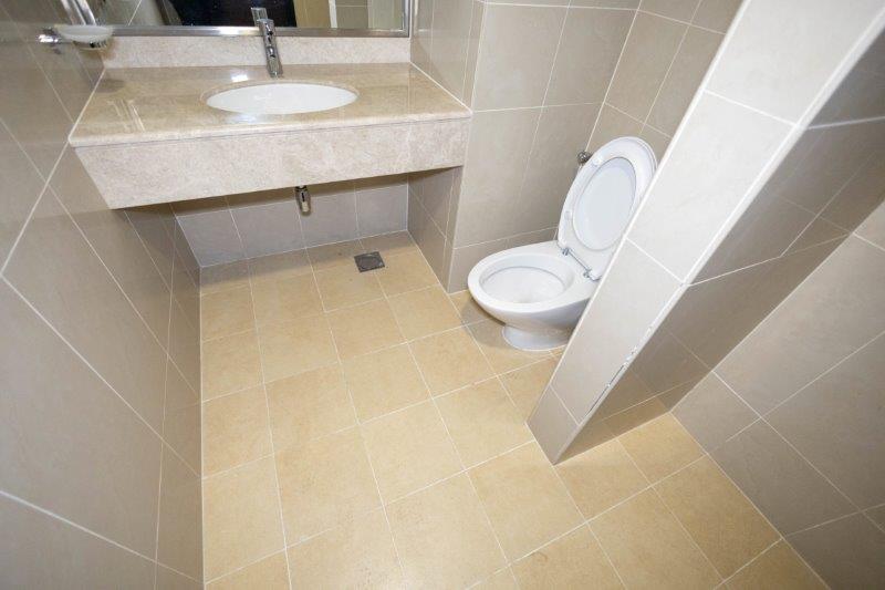 powder-room-with-beige-tiles-in-1-bedroom-apartment-in-sky-tower-al-reem