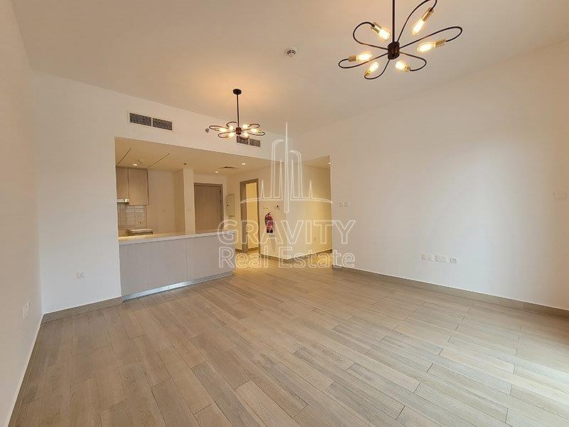 spacious-living-area-in-waters-edge-apartment-with-wood-flooring-and-modern-minimalist-light-2-bedroom-unit-for-sale