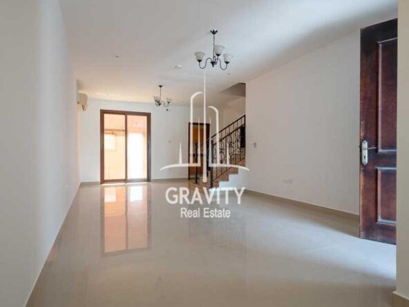 spacious-lving-hall-area-with-cozy-chandelier-hanging-from-the-slab-and-bif-window-panel-hydra-village-abu-dhabi