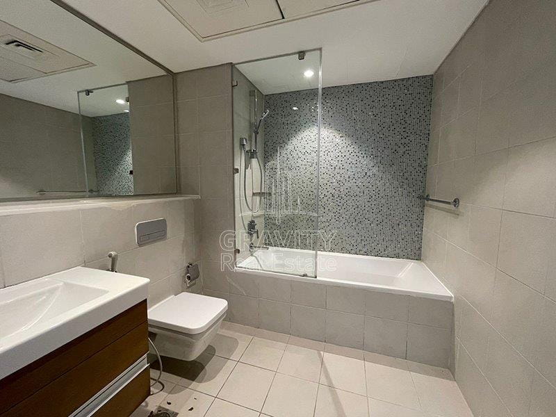 well-maintained-bathromm-w-huge-bathtub-sink-toilet-and-wide-vanity-mirror-in-2brapt-in-al-hadeel-al-bandar