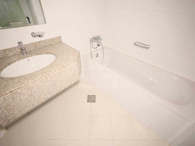 well-maintained-bathroom-equiped-w-bathtub-toilet-and-sink-in-a-studio-apartment