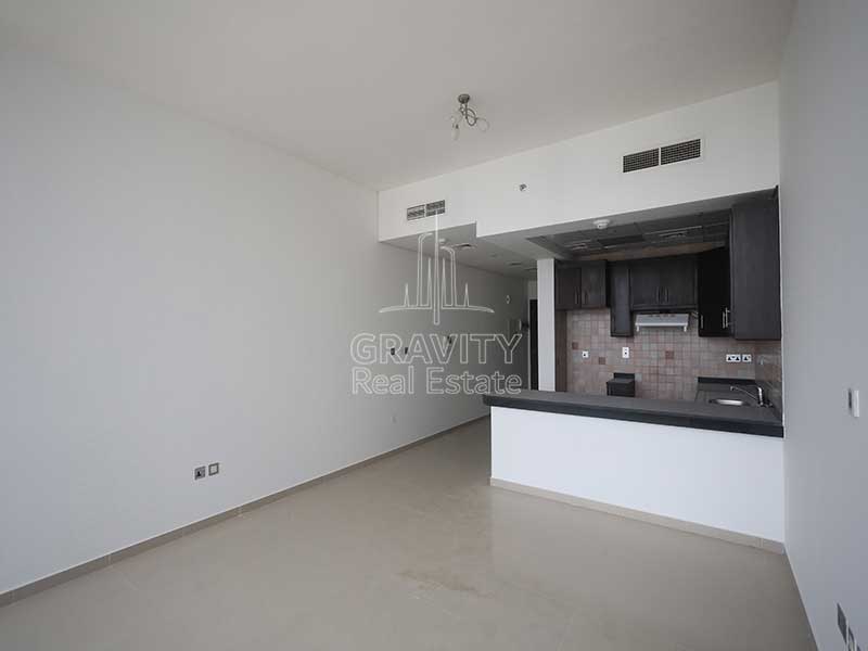 wide-living-area-with-open-kitchen-in-a-studio-apt-in-hydra-avenue-tower-c6