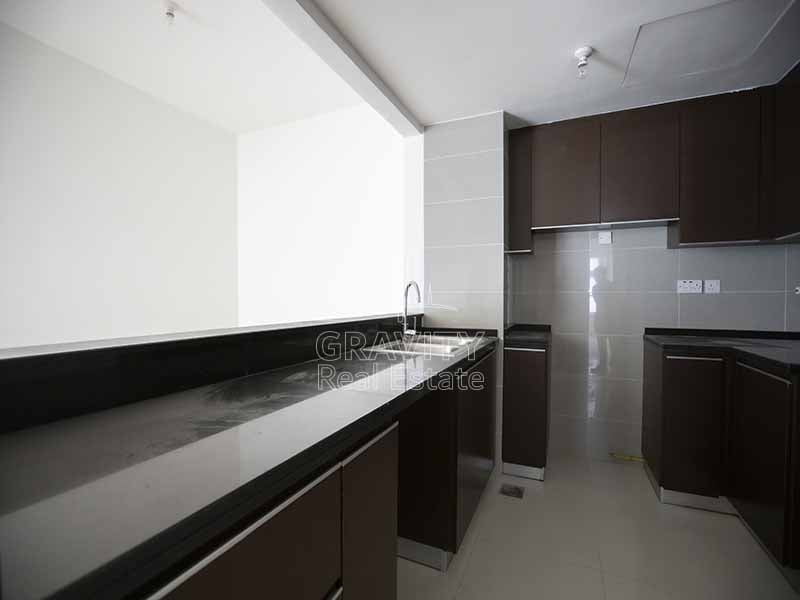 Open-kitchen-with-wooden-cabinets-in-marina-heights-tower-2