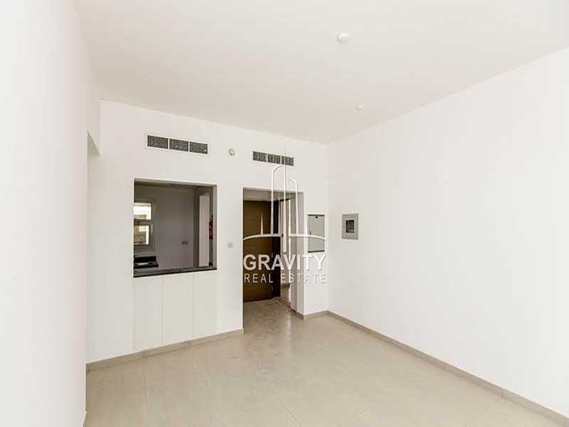 al-ghadeer-abu-dhabi-property-living-room-with-open-kitchen-and-central-ac