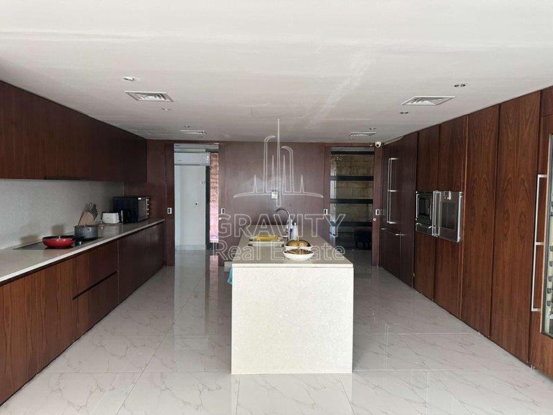 big-and-spacious-kitchen-place-with-huge-built-in-wardrobes-surrounding-the-kitchen-al-gurm-resort