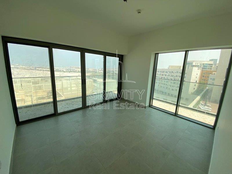 cozy-bedroom-with-glass-wall-and-door-directed-to-a-balcony-of-a-2-bedroom-apartment-in-park-view-saadiyat-for-rent