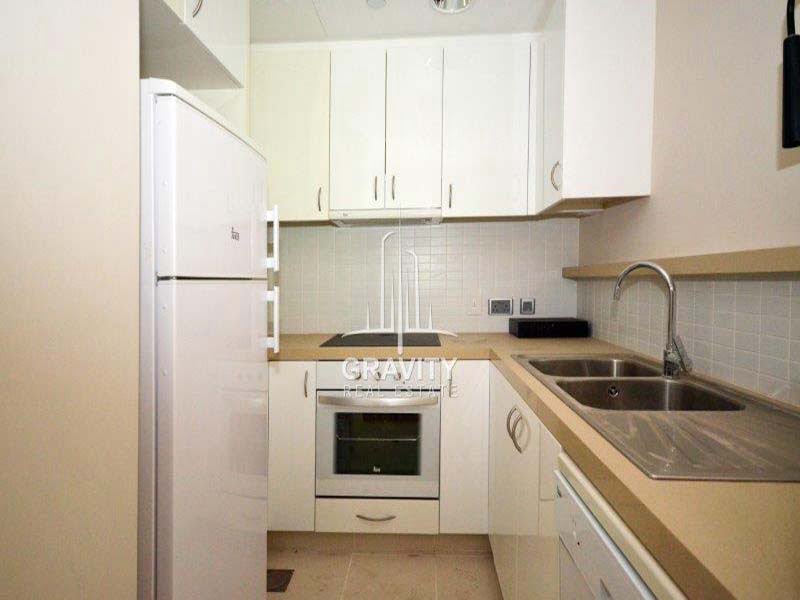 fitted-kitchen-of-a-2-bedroom-apartment-in-al-rahba-al-muneera-raha-beach-for-sale