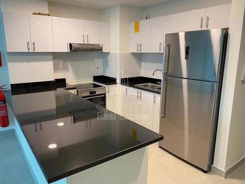 modern-fitted-kitchen-with-white-cabinets-and-cupboards-of-1bedroom-apartment-in-saadiyat-parkview-residence