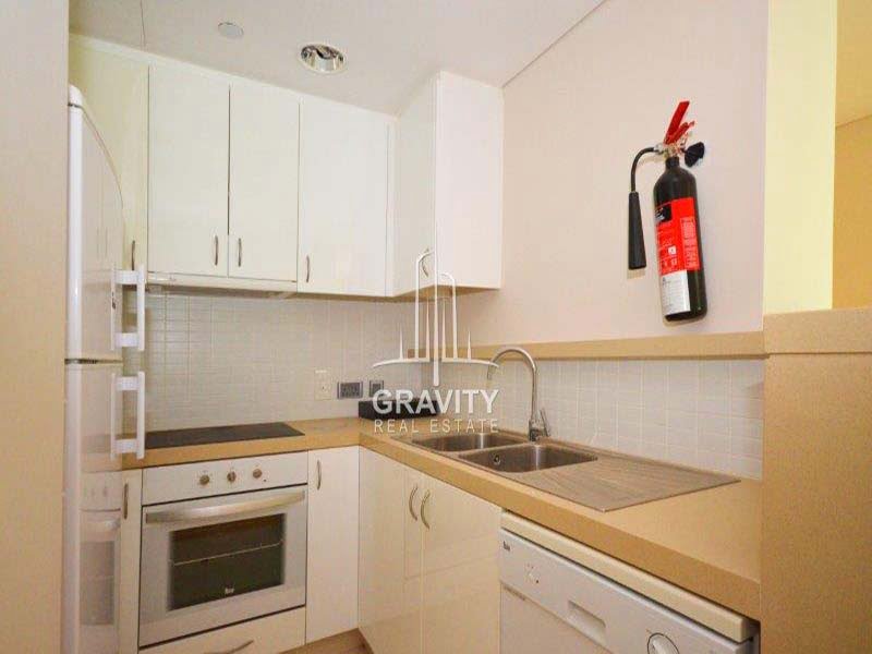 modern-kitchen-with-white-cabinets-and cupboards--of-a-2-bedroom-apartment-in-al-rahba-al-muneera