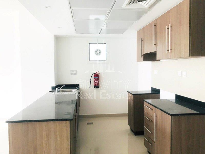 nice-kitchen-with-brown-cupboards-and-cabinets-of-a-2-bedroom-villa-in-al-reef-2-al-samha-for-sale