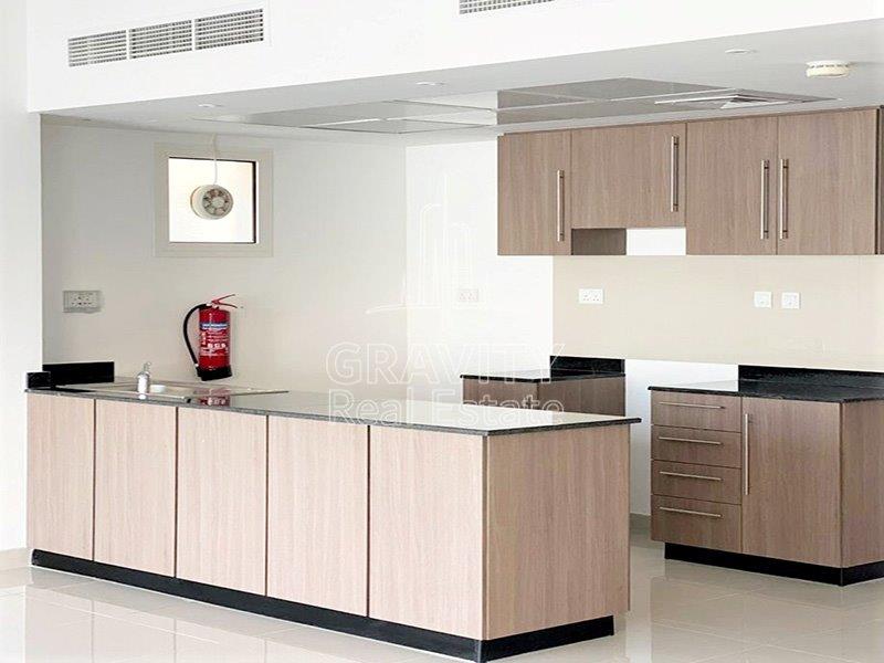 sleek-and-neat-open-kitchen-of-a-2-bedroom-villa-in-al-reef-2-al-samha-for-sale