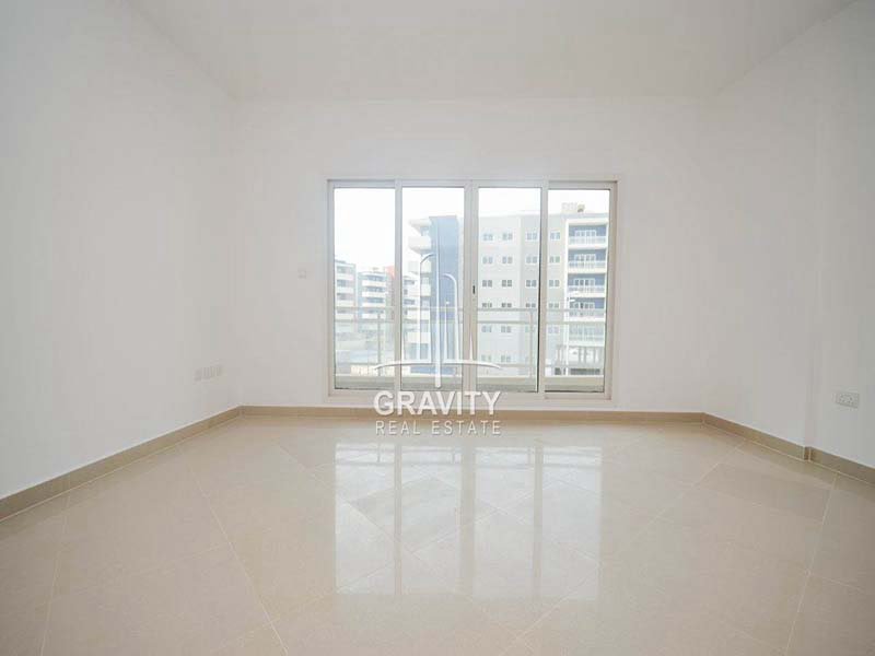 spacious-living-hall-area-with-big-glass-window-with-bright-white-walls-reef-downtown